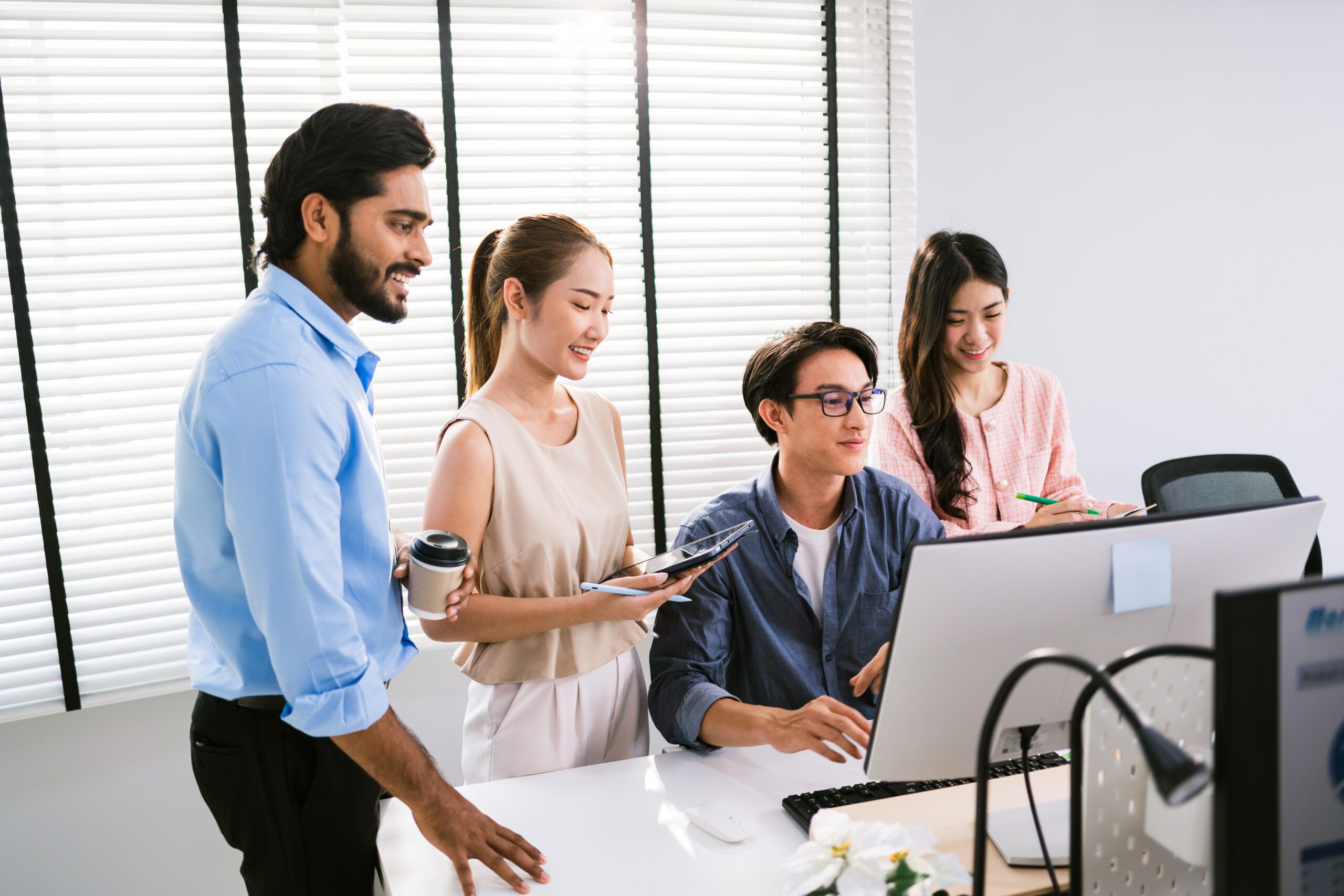 group-asian-businessmen-casual-with-one-sitting-pointing-display-colleagues